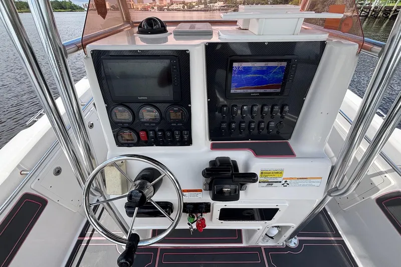 Slide: The Image of 2006 Seaswirl Striper 2601 boat dashboard with navigation and control systems. - 7