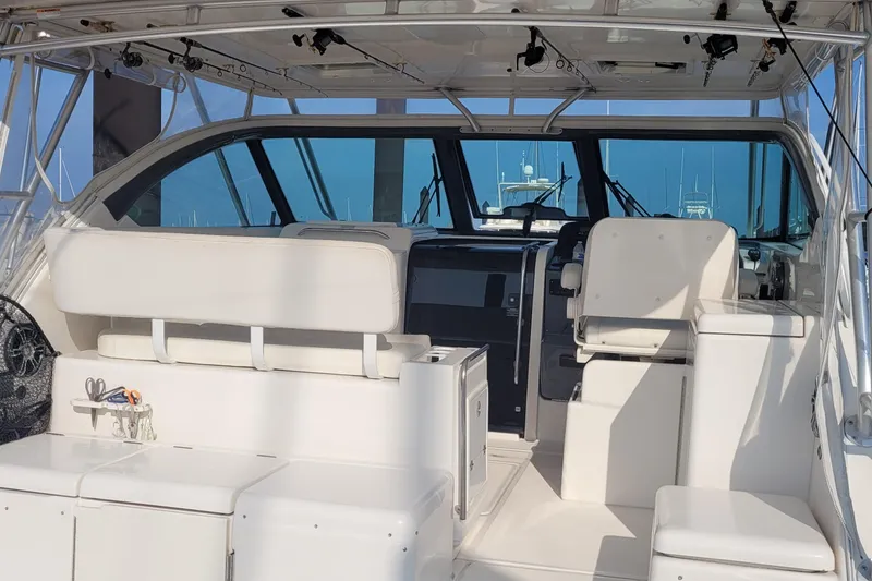 Slide: The Image of 2006 Tiara Yachts 4200 Open interior with white seating and fishing equipment. - 14
