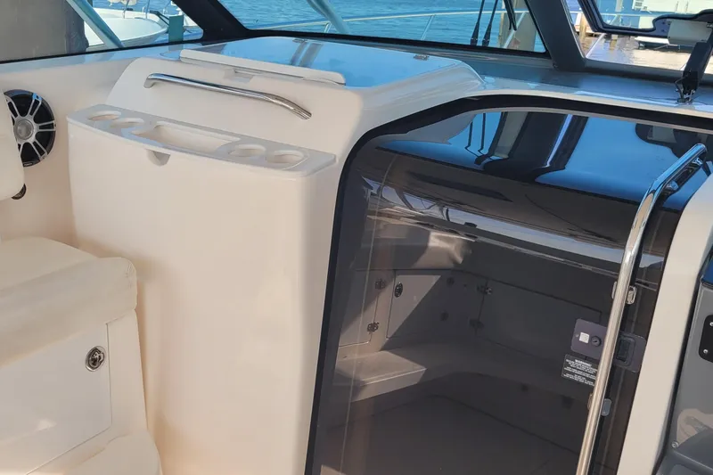 Slide: The Image of 2006 Tiara Yachts 4200 Open interior with seating and storage, showcasing luxury design. - 17