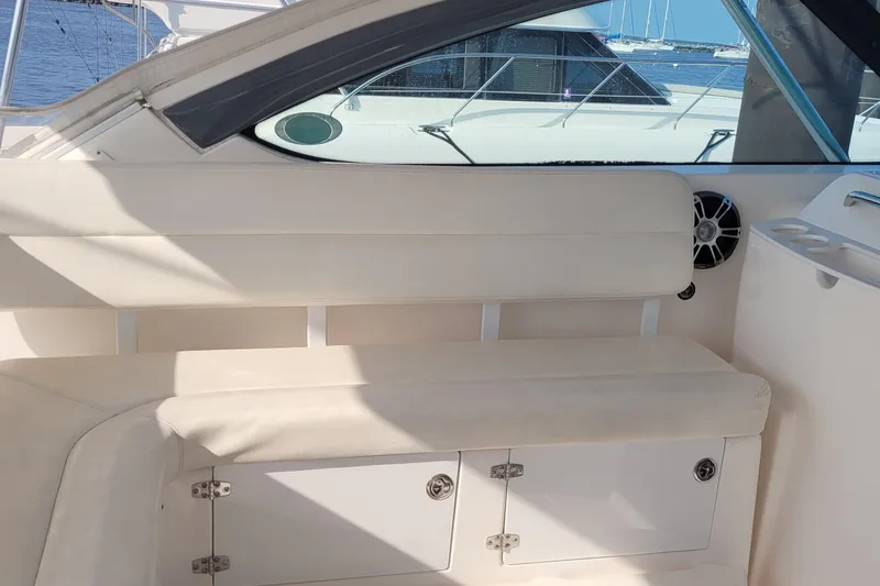 Slide: The Image of 2006 Tiara Yachts 4200 Open interior seating with storage, docked by the water. - 18