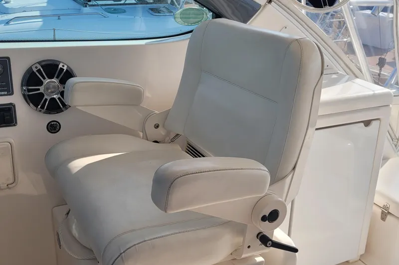 Slide: The Image of Captain's chair on 2006 Tiara Yachts 4200 Open, featuring white upholstery and control panel. - 22