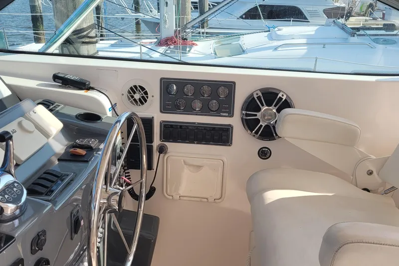 Slide: The Image of Helm of 2006 Tiara Yachts 4200 Open with steering wheel and control panel. - 23