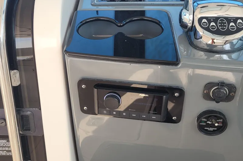 Slide: The Image of Control panel of a 2006 Tiara Yachts 4200 Open, featuring audio system and throttle controls. - 26