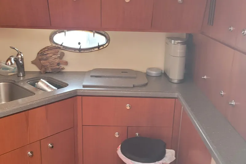 Slide: The Image of 2006 Tiara Yachts 4200 Open kitchen with wooden cabinets and modern appliances. - 30