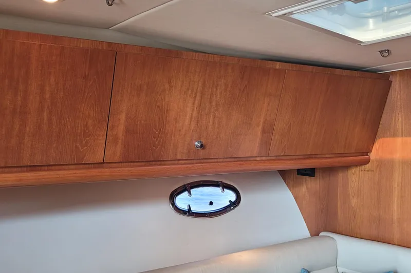 Slide: The Image of Interior of 2006 Tiara Yachts 4200 Open, featuring wooden cabinetry and a small window. - 40