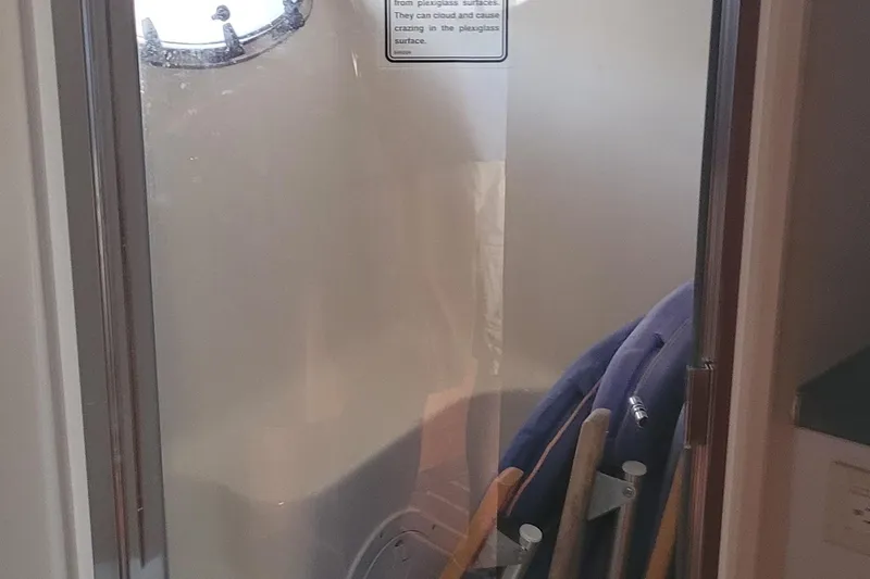 Slide: The Image of Storage area inside 2006 Tiara Yachts 4200 Open, featuring life jackets and cleaning tools. - 41