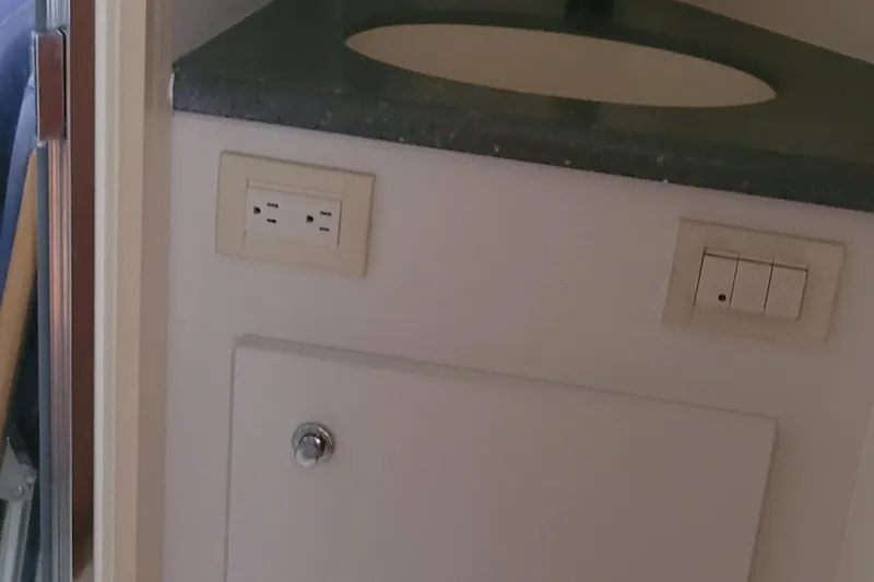 Slide: The Image of 2006 Tiara Yachts 4200 Open bathroom sink with outlet and switches. - 44