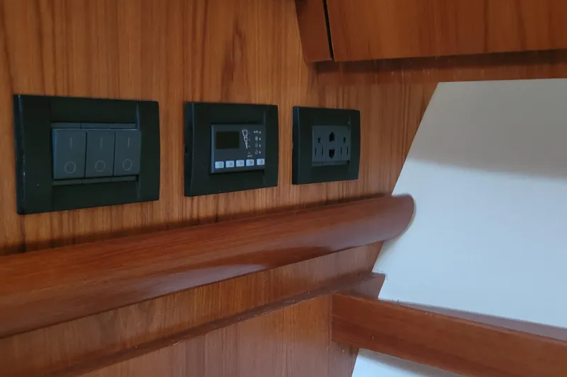 Slide: The Image of Control panel and outlets on 2006 Tiara Yachts 4200 Open wooden interior. - 47