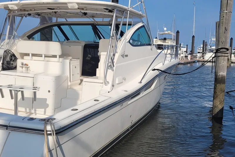 The Image of 2006 Tiara Yachts 4200 Open docked at marina, showcasing sleek design and spacious deck. - 5