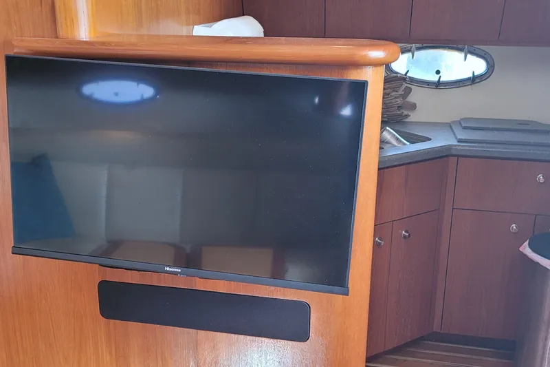 Slide: The Image of Interior of 2006 Tiara Yachts 4200 Open with TV and wooden cabinetry. - 50