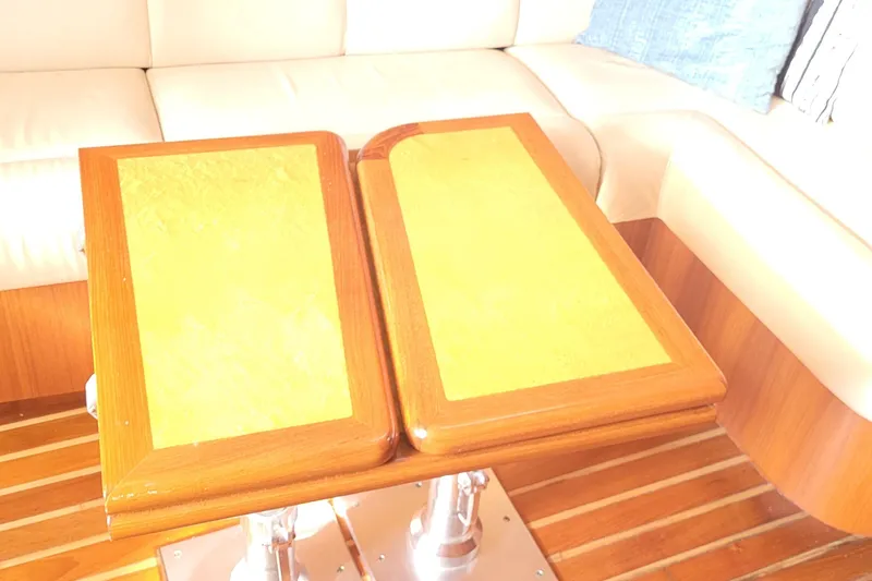 Slide: The Image of Interior of 2006 Tiara Yachts 4200 Open with wooden table and cushioned seating. - 55