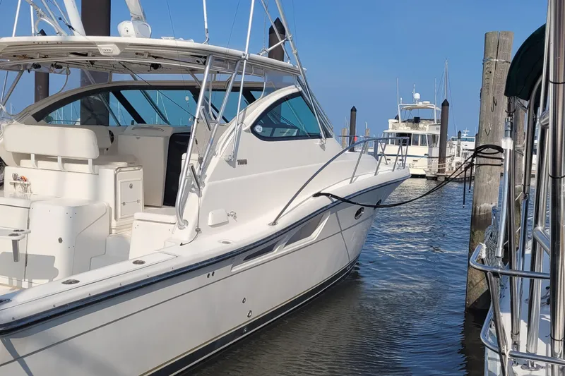 Slide: The Image of 2006 Tiara Yachts 4200 Open docked at marina, clear blue sky background. - 6
