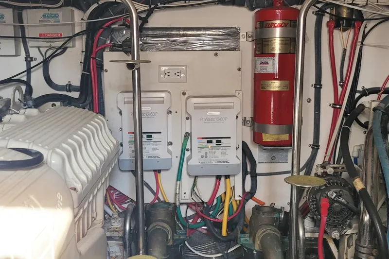Slide: The Image of Engine room of 2006 Tiara Yachts 4200 Open with electrical panels and fire extinguisher. - 60