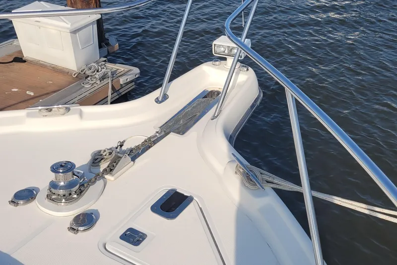 Slide: The Image of Bow of 2006 Tiara Yachts 4200 Open, featuring anchor and railing, docked by water. - 67