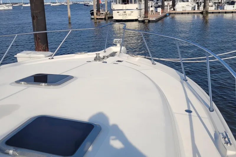 Slide: The Image of 2006 Tiara Yachts 4200 Open on calm marina waters, showcasing sleek deck design. - 68