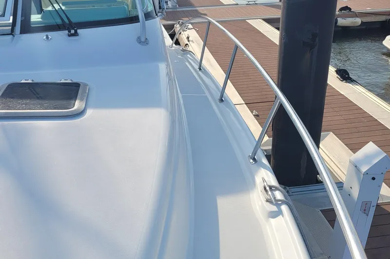 Slide: The Image of 2006 Tiara Yachts 4200 Open deck view with railing and dockside perspective. - 72