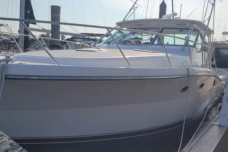 Slide: The Image of 2006 Tiara Yachts 4200 Open docked at marina, sleek design, luxury vessel. - 9