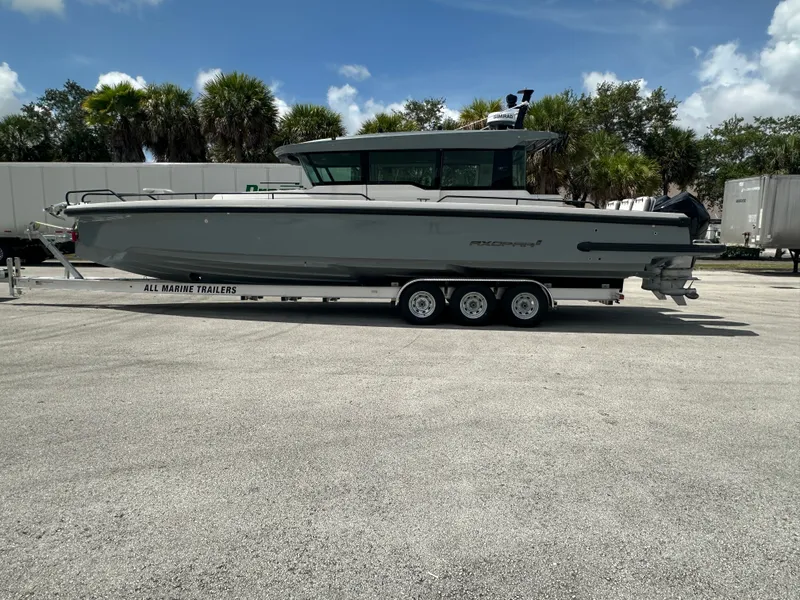 Slide: The Image of 2020 Axopar 37 XC CROSS CABIN boat on trailer, parked outdoors. - 0