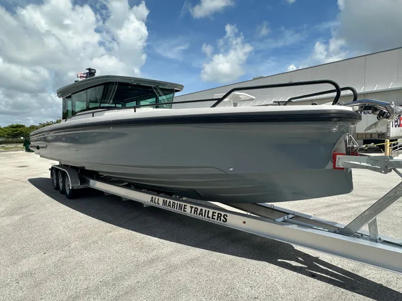 Slide: The Image of 2020 Axopar 37 XC CROSS CABIN boat on trailer under a cloudy sky. - 11