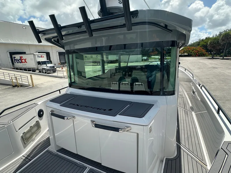 Slide: The Image of 2020 Axopar 37 XC CROSS CABIN boat docked near FedEx trucks. - 15