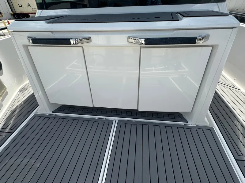 Slide: The Image of Axopar 37 XC CROSS CABIN 2020, sleek white cabinetry and deck flooring. - 16