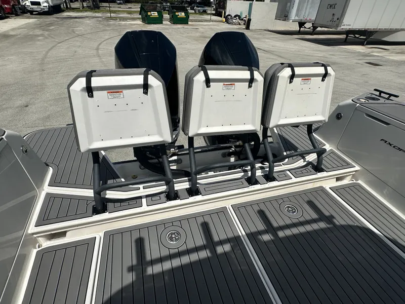 Slide: The Image of 2020 Axopar 37 XC CROSS CABIN boat with triple outboard engines, docked on a sunny day. - 17
