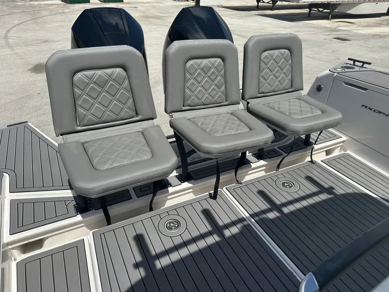 Slide: The Image of Three gray cushioned seats on 2020 Axopar 37 XC CROSS CABIN boat deck. - 19