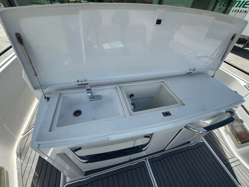 Slide: The Image of Axopar 37 XC CROSS CABIN 2020 boat sink and storage area. - 21