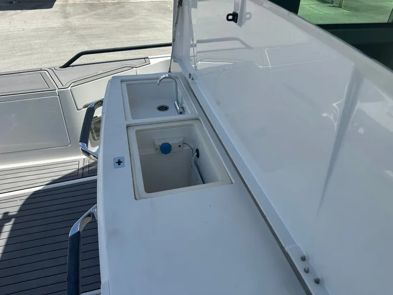 Slide: The Image of 2020 Axopar 37 XC CROSS CABIN boat sink and storage area. - 22