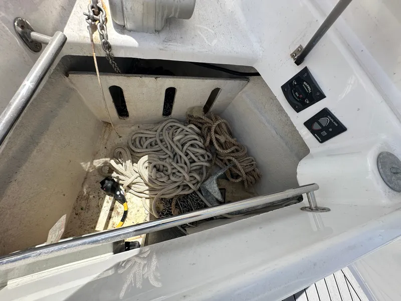 Slide: The Image of Anchor storage compartment on 2020 Axopar 37 XC CROSS CABIN with ropes and controls. - 31
