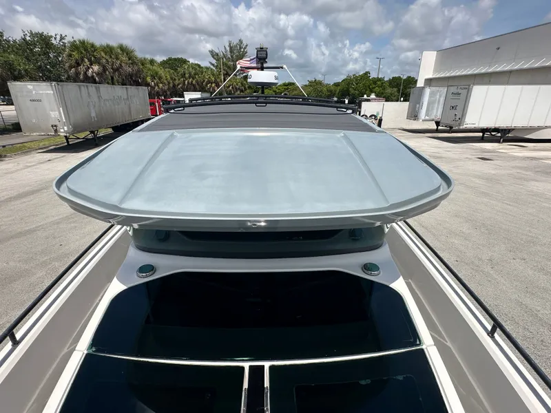 Slide: The Image of 2020 Axopar 37 XC CROSS CABIN boat with open sunroof, parked outdoors. - 32