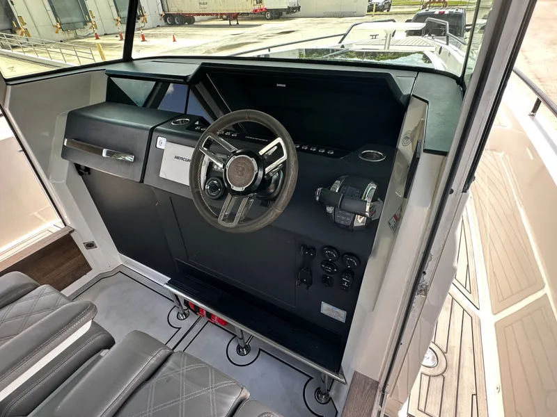 Slide: The Image of Interior view of 2020 Axopar 37 XC CROSS CABIN helm with steering wheel and controls. - 35