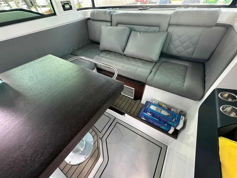 Slide: The Image of Luxurious interior of 2020 Axopar 37 XC CROSS CABIN with gray seating and wooden table. - 36