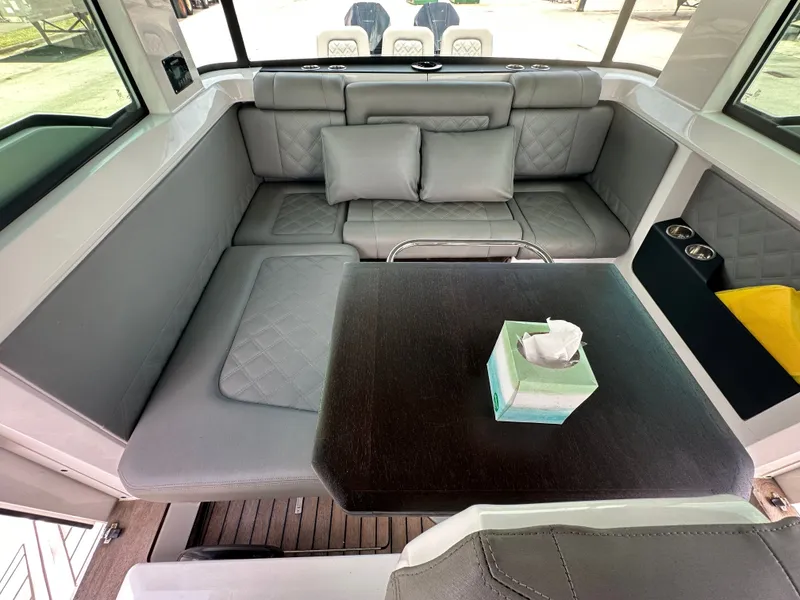 Slide: The Image of Luxurious interior of 2020 Axopar 37 XC CROSS CABIN with plush seating and table. - 37