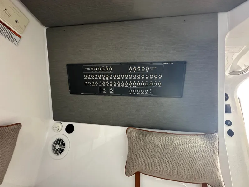 Slide: The Image of Control panel inside 2020 Axopar 37 XC CROSS CABIN boat, featuring multiple switches and outlets. - 39