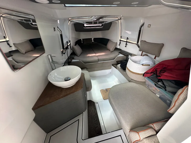 Slide: The Image of 2020 Axopar 37 XC CROSS CABIN interior with modern seating and compact sink. - 40