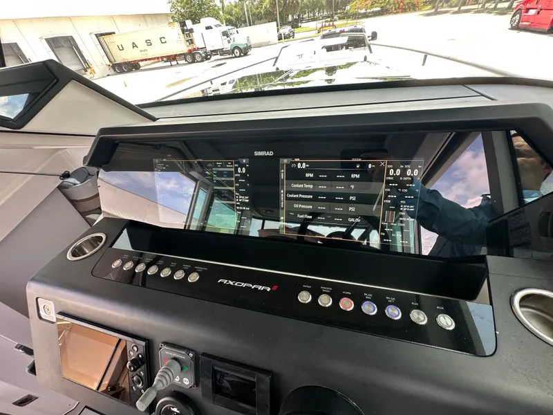 Slide: The Image of Dashboard of 2020 Axopar 37 XC CROSS CABIN with Simrad display and control panel. - 44