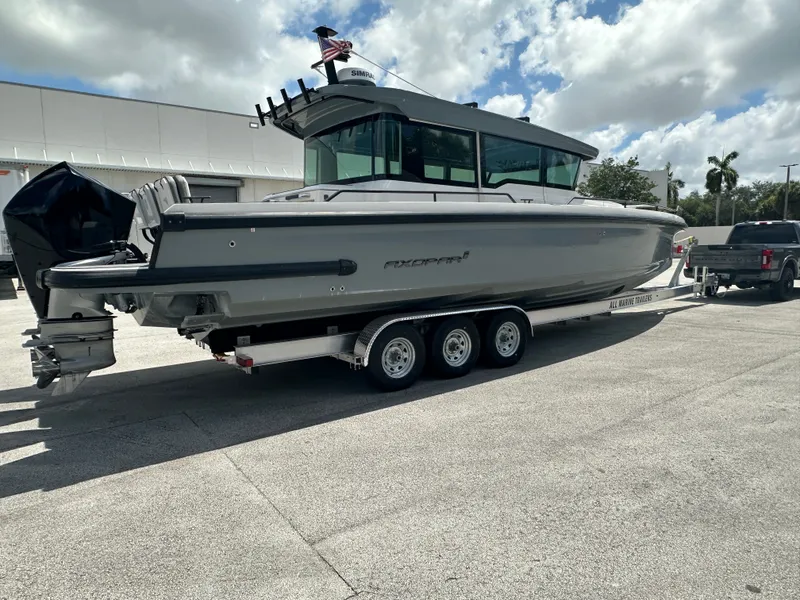 Slide: The Image of 2020 Axopar 37 XC CROSS CABIN boat on trailer, parked outdoors. - 7