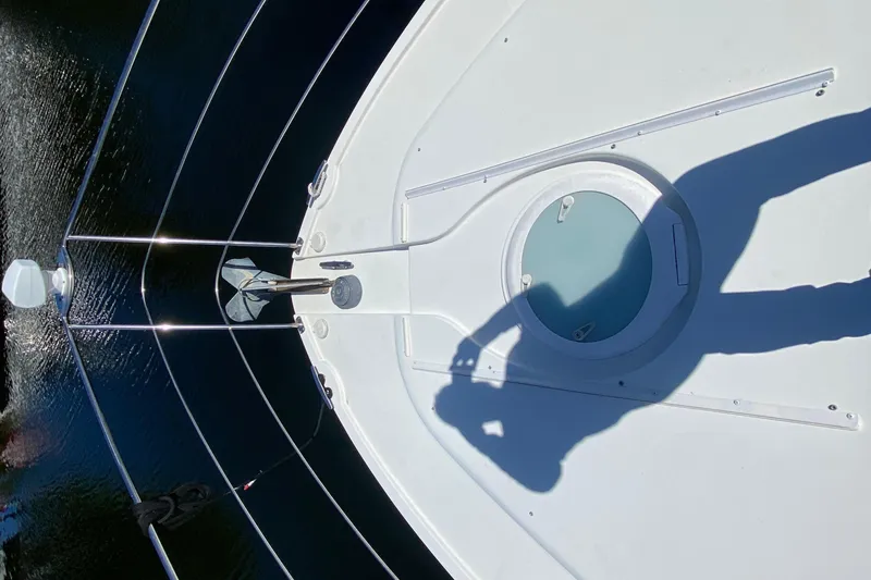 Slide: The Image of 2006 Carver 33 Super Sport yacht deck with shadow and water reflection. - 12