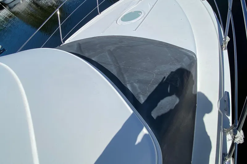Slide: The Image of 2006 Carver 33 Super Sport yacht deck with railing and water reflection. - 13