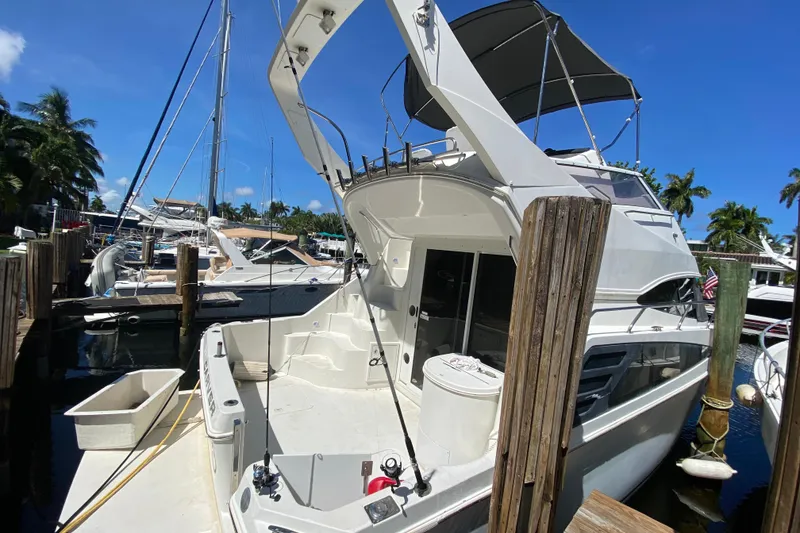 Slide: The Image of 2006 Carver 33 Super Sport yacht docked at marina under clear blue sky. - 17