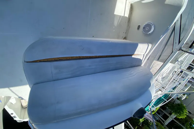 Slide: The Image of 2006 Carver 33 Super Sport boat seat with visible tear and wear. - 23