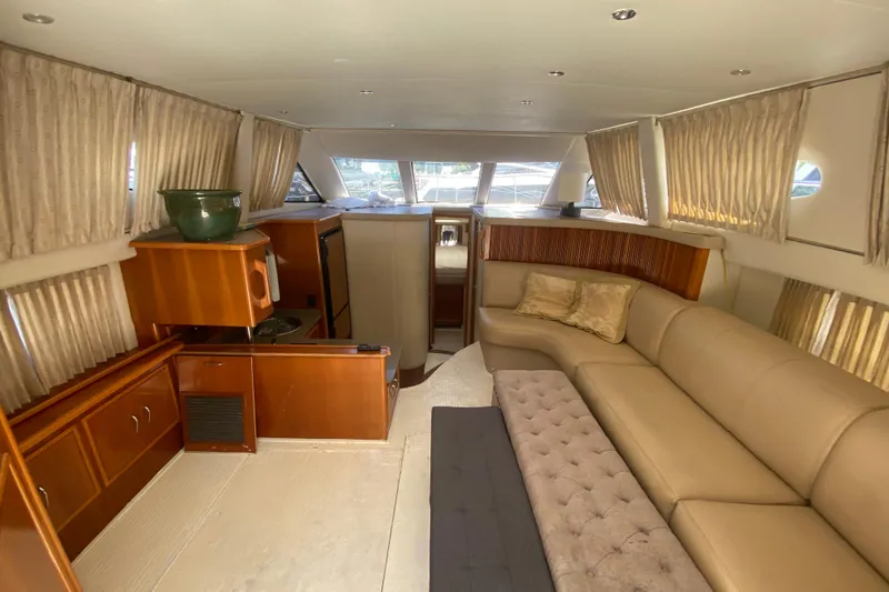 Slide: The Image of Interior of 2006 Carver 33 Super Sport yacht with beige seating and wooden cabinetry. - 24