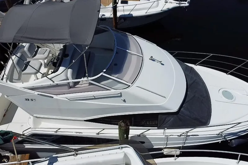 Slide: The Image of 2006 Carver 33 Super Sport yacht with canopy, docked at marina. - 29