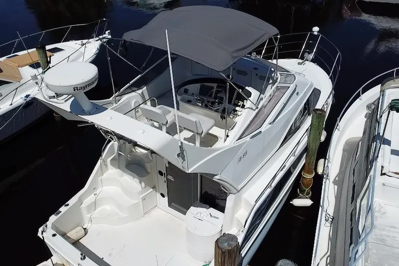 Slide: The Image of 2006 Carver 33 Super Sport yacht docked, featuring spacious deck and modern design. - 31