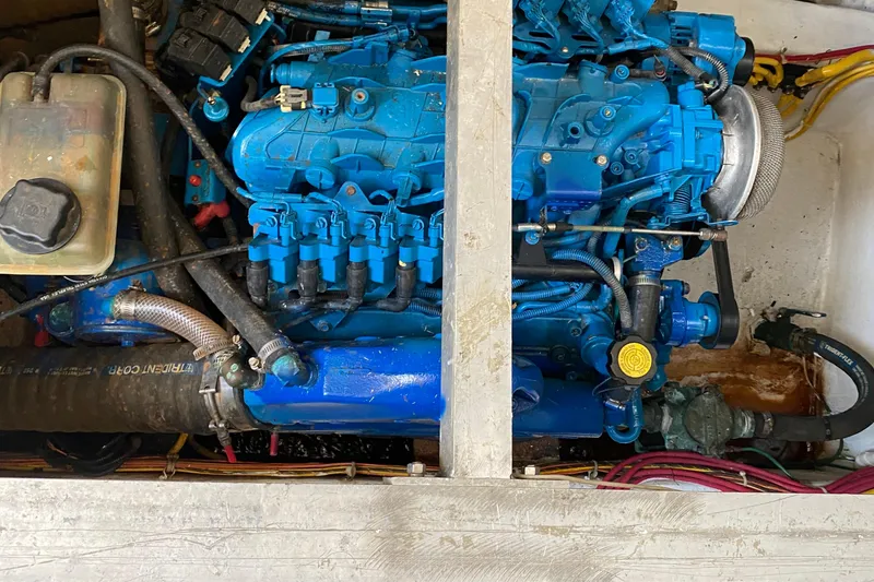 Slide: The Image of Engine compartment of a 2006 Carver 33 Super Sport boat, featuring a blue engine. - 37