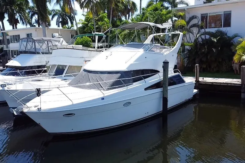 The Image of 2006 Carver 33 Super Sport yacht docked in a serene marina setting. - 0