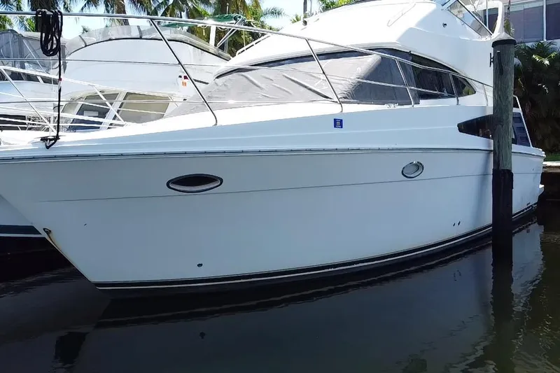 Slide: The Image of 2006 Carver 33 Super Sport yacht docked in a marina. - 10