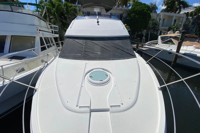Slide: The Image of 2006 Carver 33 Super Sport yacht docked, featuring sleek design and spacious deck. - 11