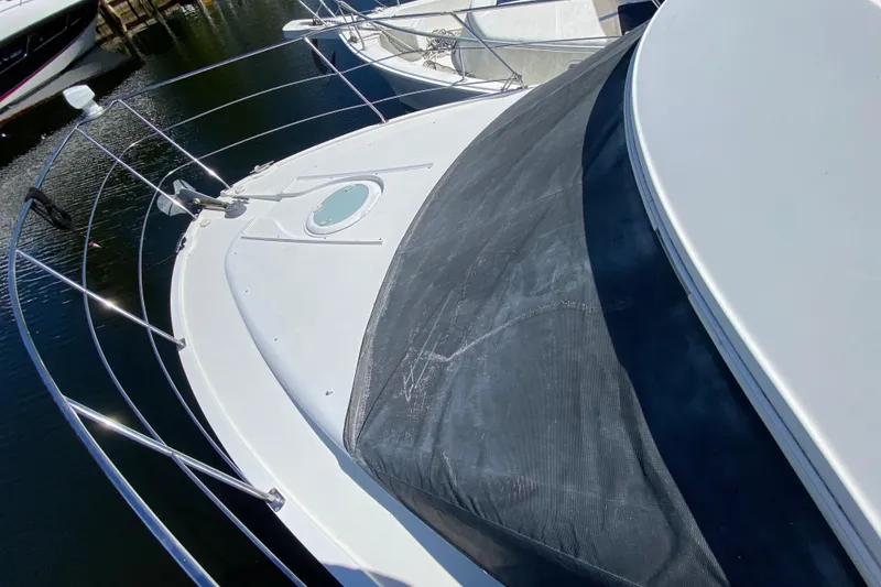 Slide: The Image of 2006 Carver 33 Super Sport yacht deck with railing and hatch, docked in marina. - 14